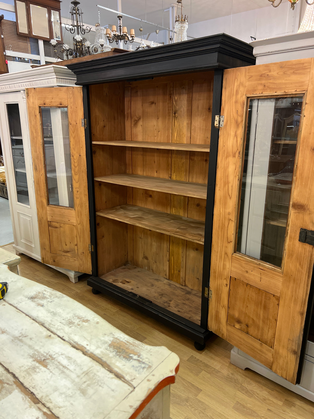 Stylish black antique display cabinet. W. 131cm, D. 57cm, H. 190.5cm.