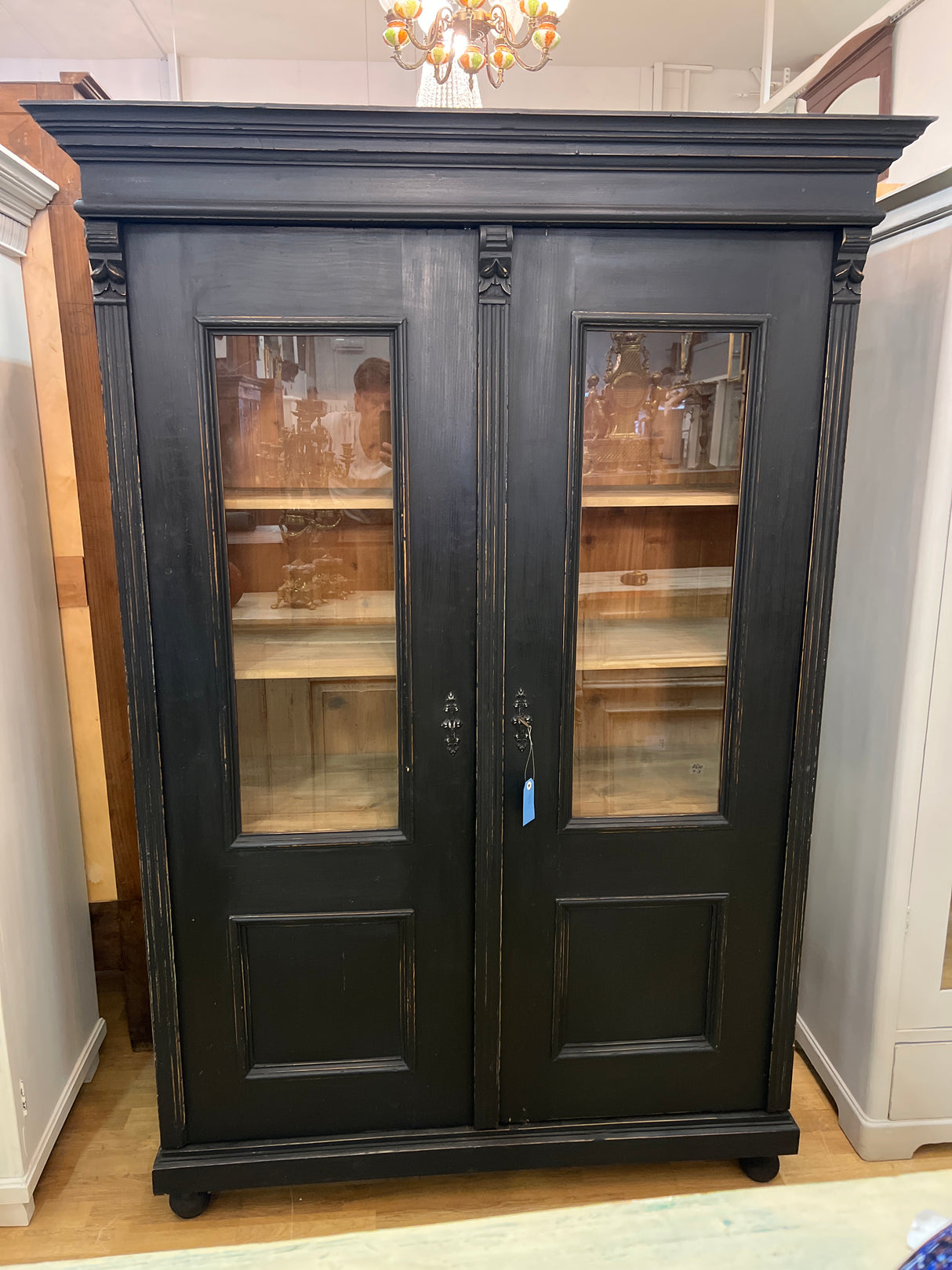 Stylish black antique display cabinet. W. 131cm, D. 57cm, H. 190.5cm.