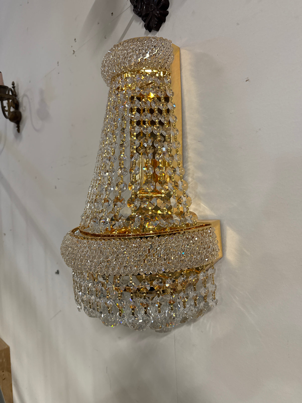 Beautiful gold-colored crystal wall lamp