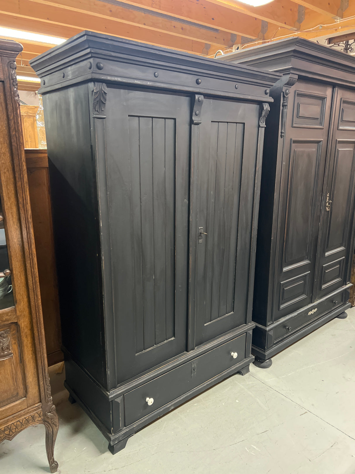 Black wardrobe W. 107.5cm, D. 55cm and H. 173.5cm.