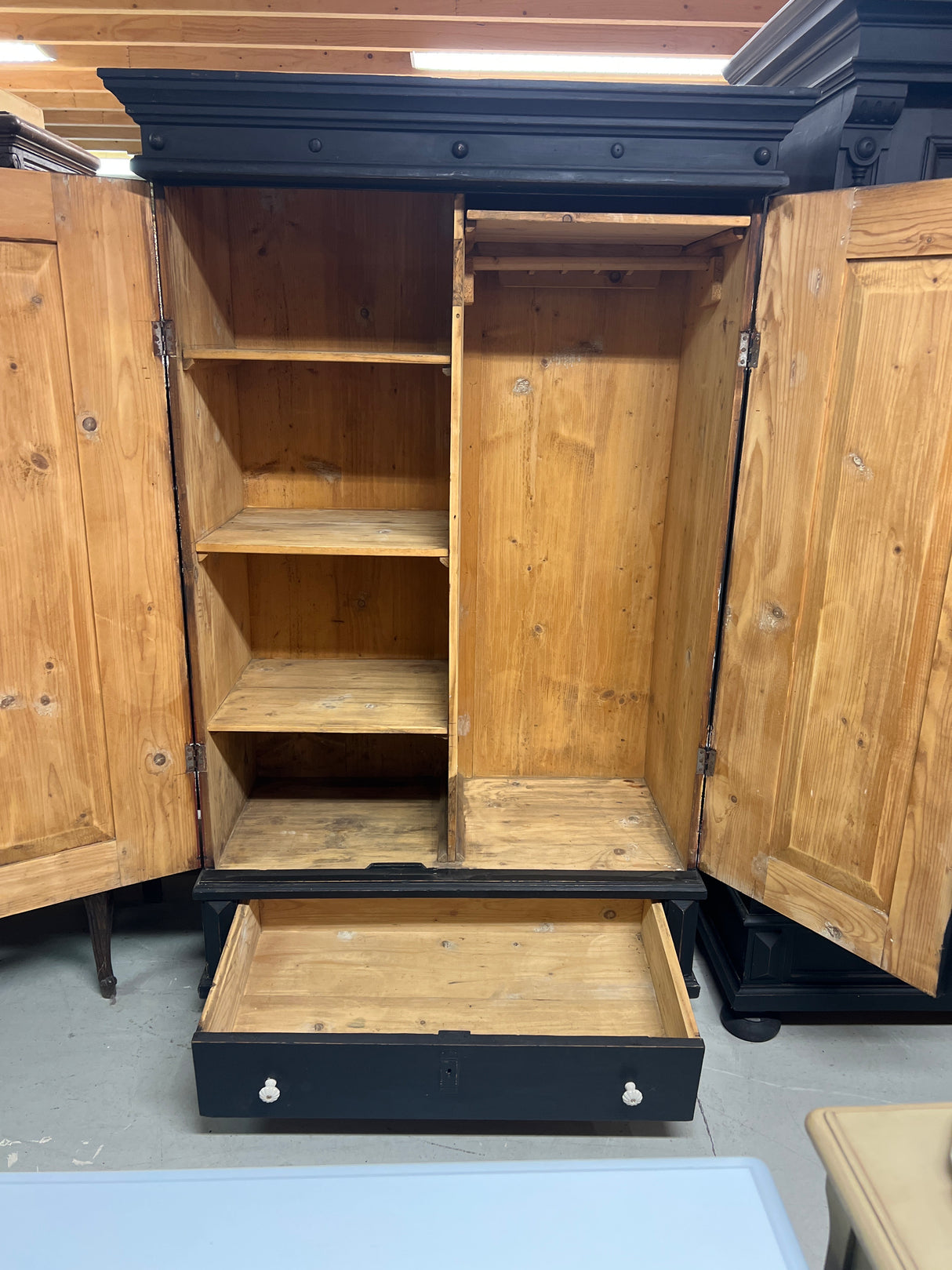 Black wardrobe W. 107.5cm, D. 55cm and H. 173.5cm.