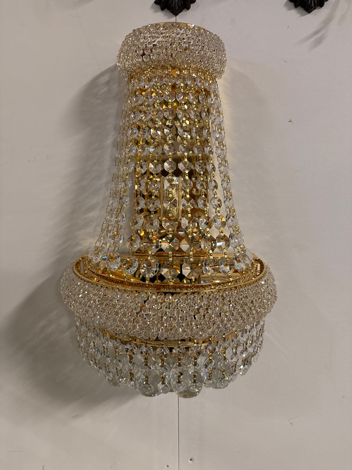Beautiful gold-colored crystal wall lamp